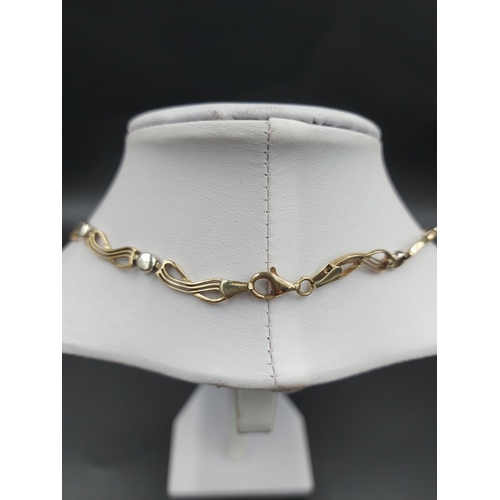 140 - A stamped 9ct yellow and white gold 45cm necklace - approx. gross weight 13.63 grams