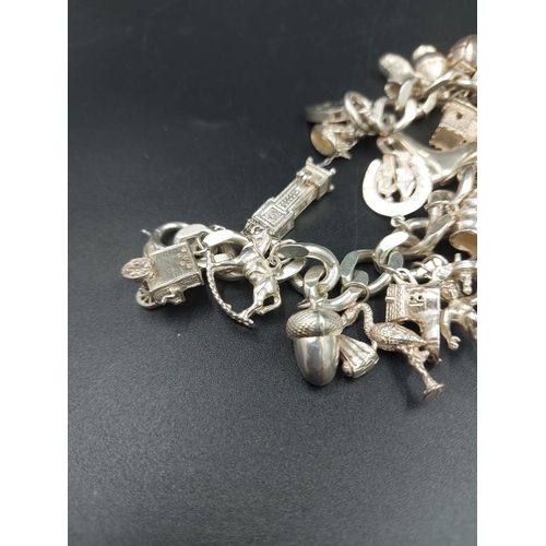 168 - A hallmarked London silver charm bracelet containing various silver charms - approx. gross weight 10... 