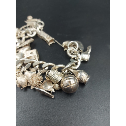 168 - A hallmarked London silver charm bracelet containing various silver charms - approx. gross weight 10... 