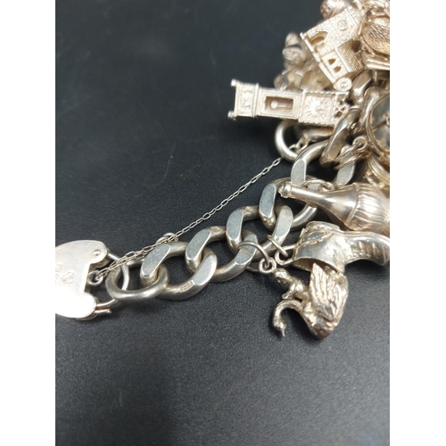 168 - A hallmarked London silver charm bracelet containing various silver charms - approx. gross weight 10... 