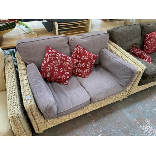 553 - A modern wicker and brown upholstered two seater sofa