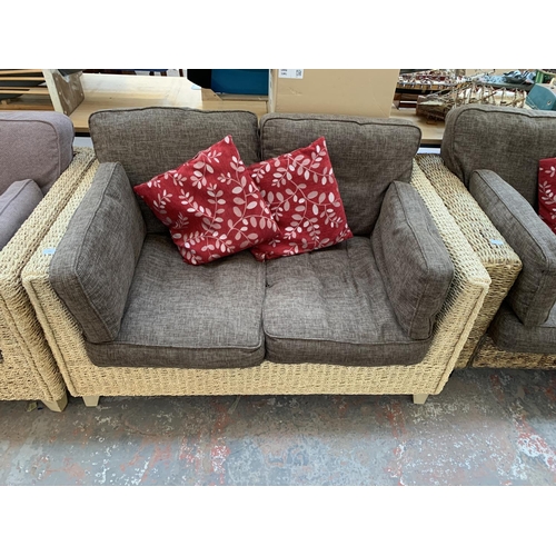 554 - A modern wicker and brown upholstered two seater sofa