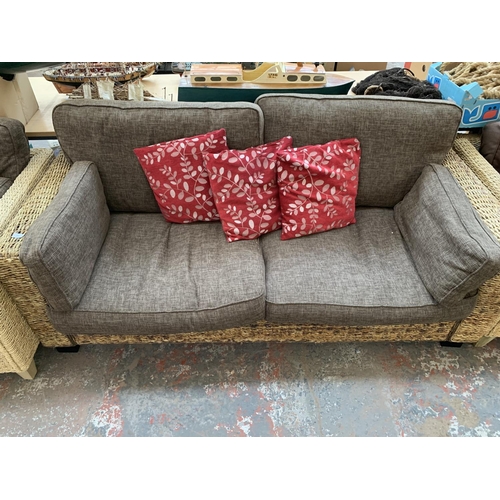 555 - A modern wicker and brown upholstered two seater sofa