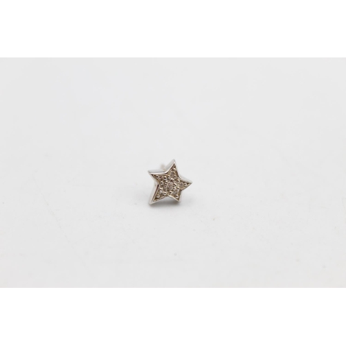 104 - A pair of 14ct gold diamond star design stud earrings - approx. gross weight 1.5 grams