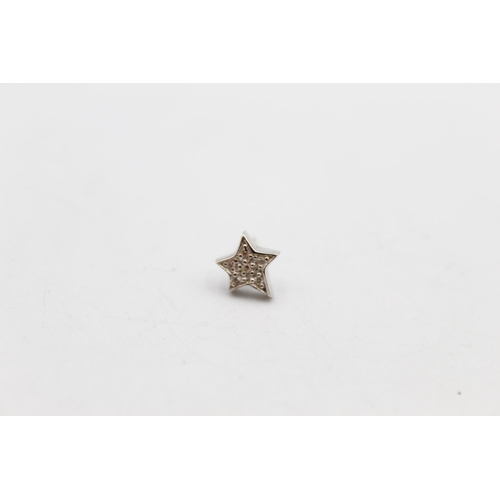 104 - A pair of 14ct gold diamond star design stud earrings - approx. gross weight 1.5 grams