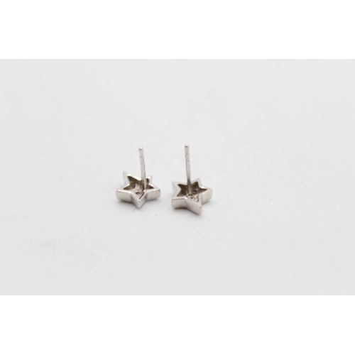 104 - A pair of 14ct gold diamond star design stud earrings - approx. gross weight 1.5 grams