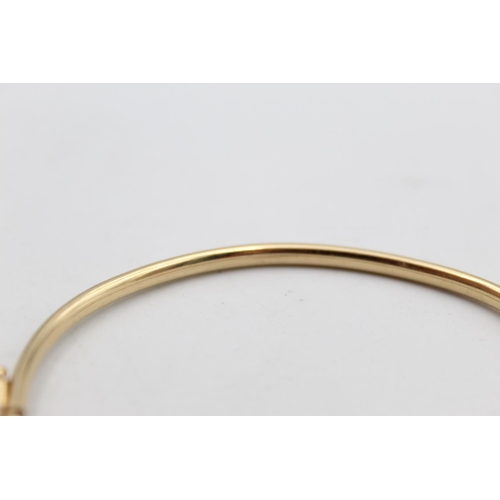 105 - A 10ct gold diamond set bangle - approx. gross weight 5.8 grams