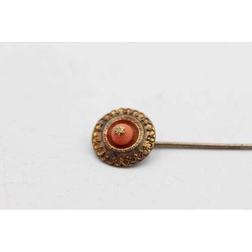 120 - An 18ct gold top coral and diamond set stick pin - approx. gross weight 2.8 grams