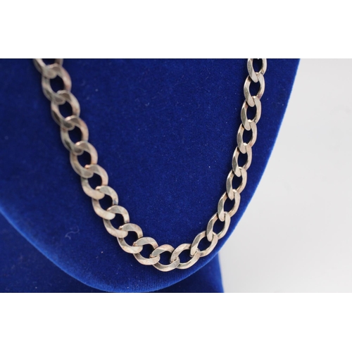 140 - A 925 sterling silver necklace with flat curb links - approx. 56cm long and gross weight 27 grams