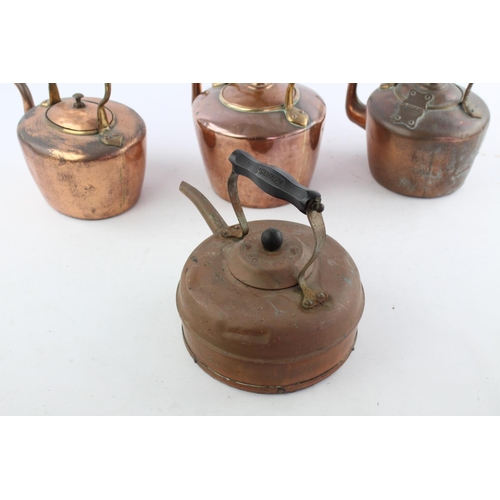 484 - Four various copper kettles to include two 19th century Soutterware examples