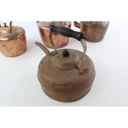 484 - Four various copper kettles to include two 19th century Soutterware examples