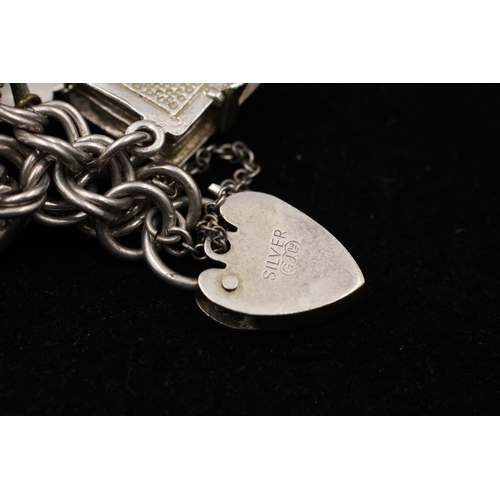 153 - A 925 sterling silver charm bracelet with heart padlock - approx. gross weight 56 grams and 15cm lon... 