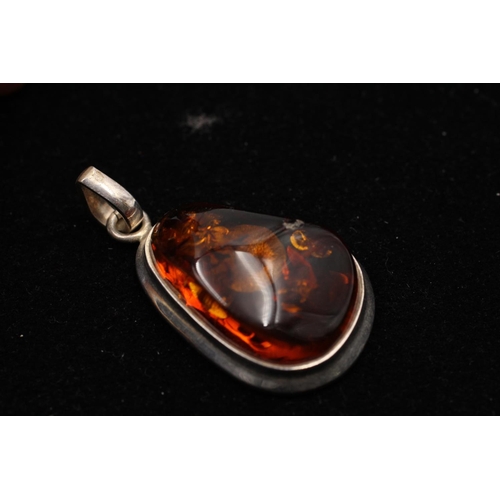 164 - Three 925 sterling silver amber pendants to include cabochon, butterscotch and pear