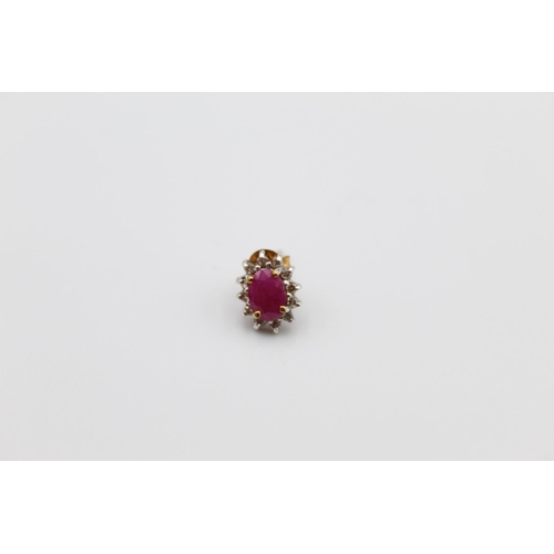 21 - A pair of 9ct gold ruby and diamond halo stud earrings - approx. gross weight 1.3g