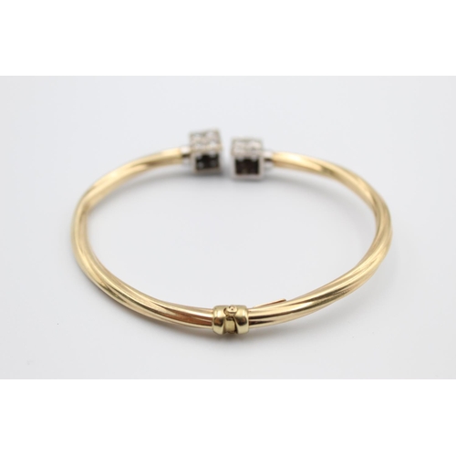 31 - A 9ct gold torque bangle with cuboid ends - approx. gross weight 9.2 grams