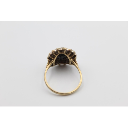 32 - A 9ct gold gemstone and diamond halo cocktail ring, size R - approx. gross weight 4.6 grams