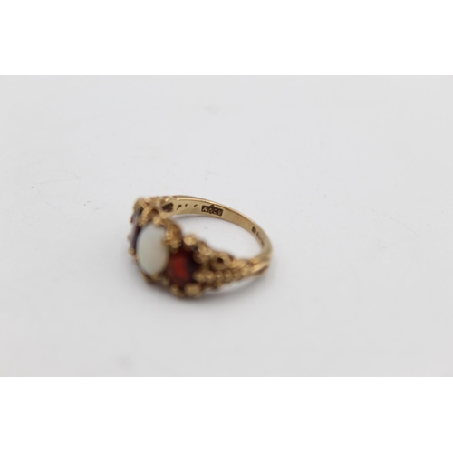 44 - A 9ct gold garnet and opal gypsy style ring, size J - approx. gross weight 4 grams