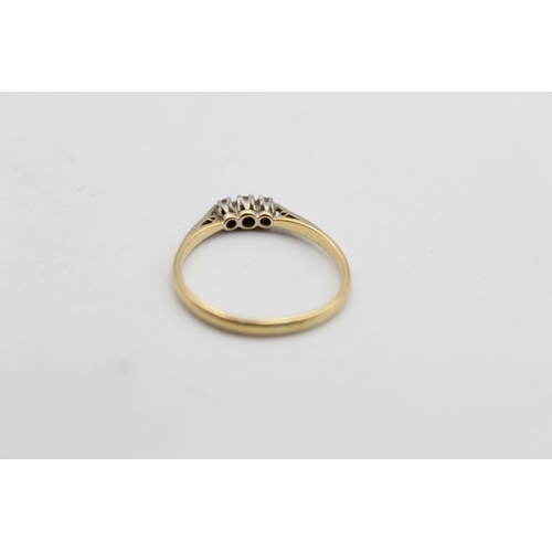 61 - An 18ct gold and platinum diamond trilogy ring, size R½ - approx. 2 grams