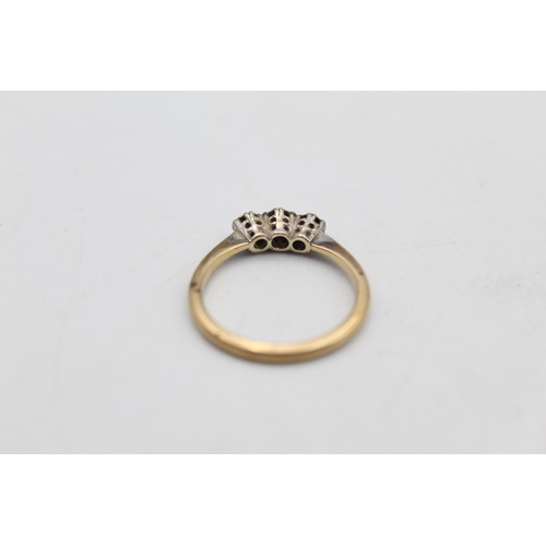 67 - A 9ct gold and platinum diamond trilogy ring, size N - approx. gross weight 2.3 grams