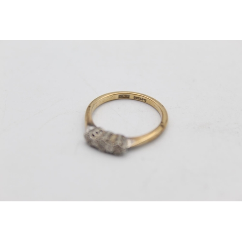 67 - A 9ct gold and platinum diamond trilogy ring, size N - approx. gross weight 2.3 grams