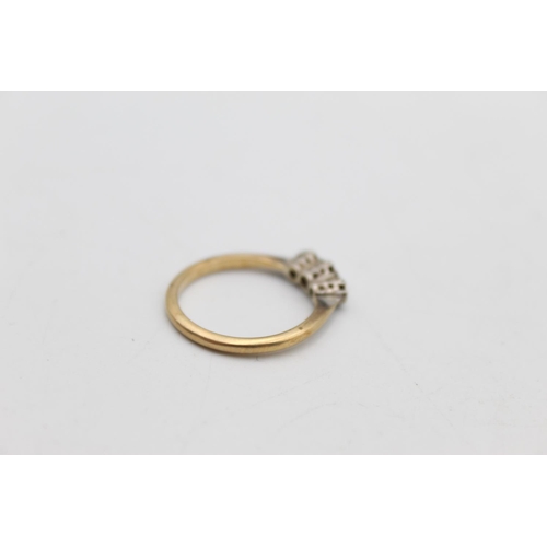 67 - A 9ct gold and platinum diamond trilogy ring, size N - approx. gross weight 2.3 grams