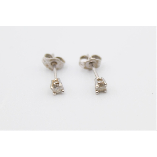 92 - A pair of 9ct white gold diamond stud earrings - approx. gross weight 0.6 grams