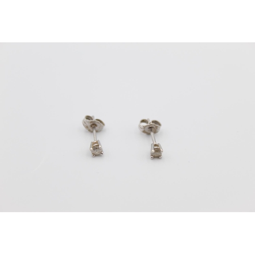 92 - A pair of 9ct white gold diamond stud earrings - approx. gross weight 0.6 grams