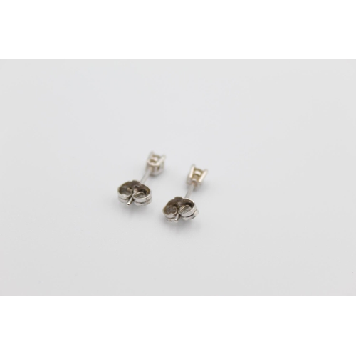 92 - A pair of 9ct white gold diamond stud earrings - approx. gross weight 0.6 grams