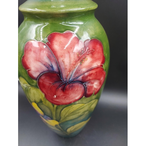 372 - A Moorcroft Hibiscus pattern table lamp - approx. 38cm high