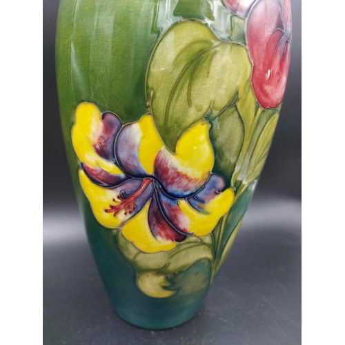 372 - A Moorcroft Hibiscus pattern table lamp - approx. 38cm high