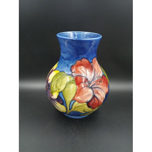 374 - A Moorcroft Hibiscus pattern vase - approx. 24cm high