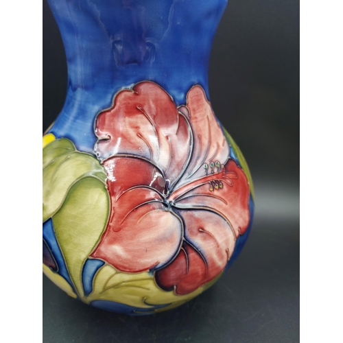 374 - A Moorcroft Hibiscus pattern vase - approx. 24cm high