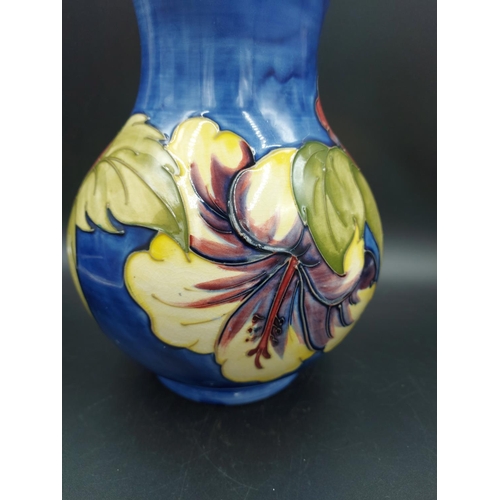 374 - A Moorcroft Hibiscus pattern vase - approx. 24cm high