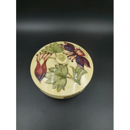 376 - A Moorcroft Columbine pattern circular lidded trinket box - approx. 13cm diameter x 8.5cm high with ... 