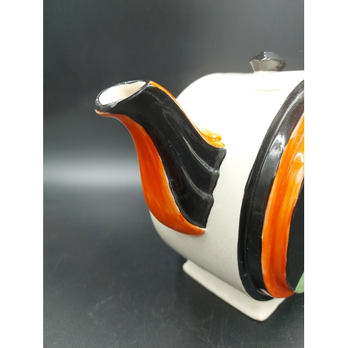 379 - An Art Deco style hand painted teapot in the manner of Clarice Cliff  - approx. 15cm high x 21cm lon... 