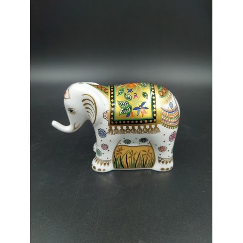 389 - A boxed Royal Crown Derby Infant Indian Elephant paperweight with gold stopper - approx. 7.5cm high ... 