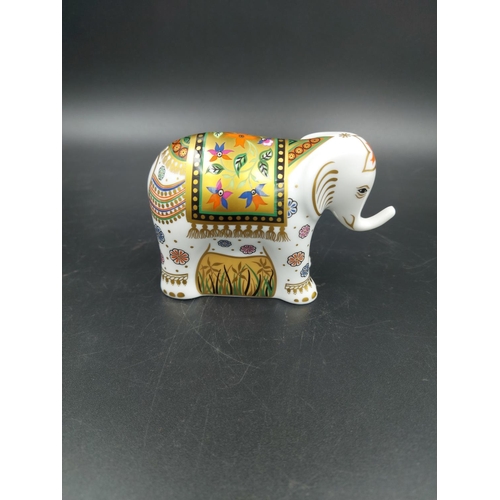 389 - A boxed Royal Crown Derby Infant Indian Elephant paperweight with gold stopper - approx. 7.5cm high ... 