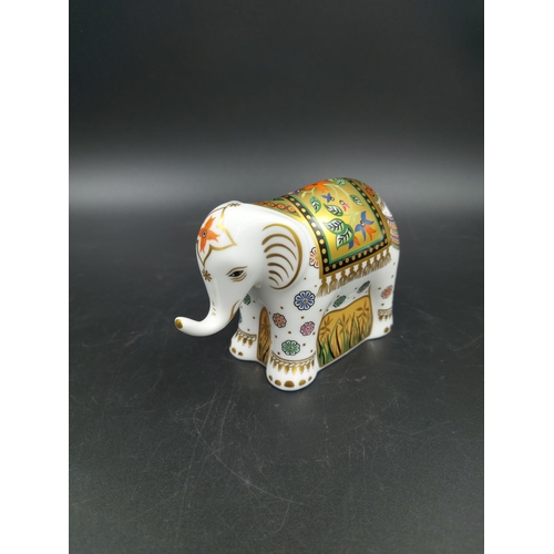 389 - A boxed Royal Crown Derby Infant Indian Elephant paperweight with gold stopper - approx. 7.5cm high ... 