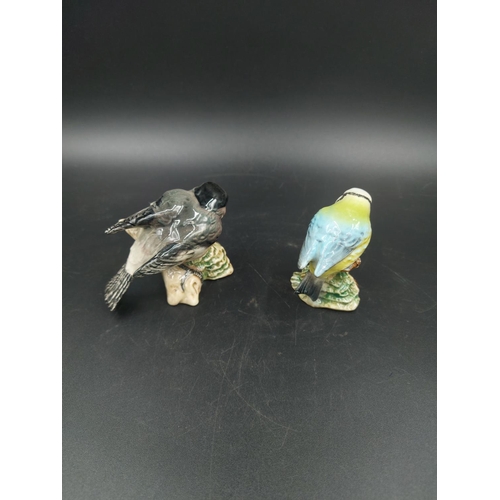 391 - Four various figurines, one Lladro Boy Blowing model no. 4869, one Beswick Bluetit model no. 992, on... 