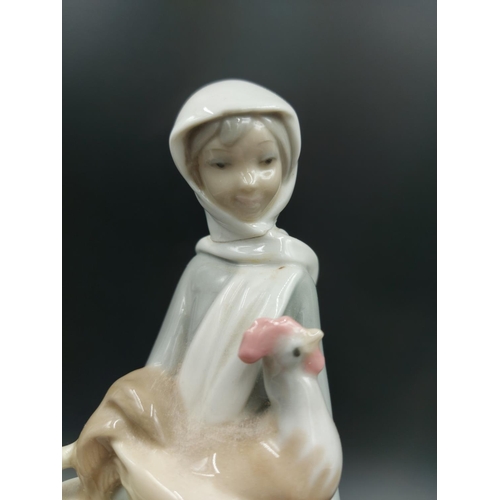 392 - Three figurines, one Lladro Angel With Flute model  no. 4540, one Lladro Lady With Basket and Chicke... 