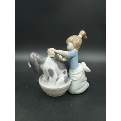 395 - Three various figurines, one Lladro Bashful Bather model no. 5455, one Nao Choir Boys ringing bell m... 