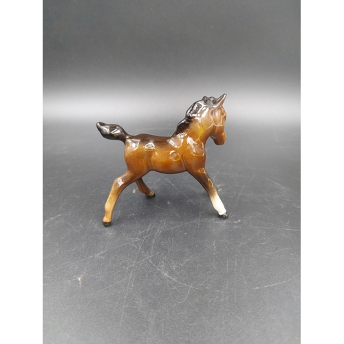 402 - Two Beswick brown horse figurines, one Stocky Jogging Mare and one Foal