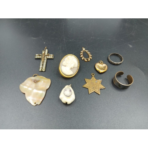 217 - A collection of various costume jewellery to include rolled 9ct gold heart pendant, Swastika pendant... 