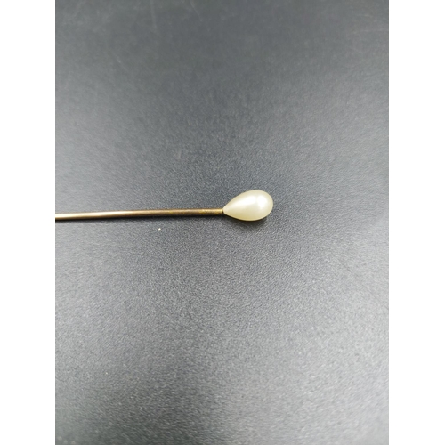 231 - A vintage yellow metal ladies stick pin with simulated pearl