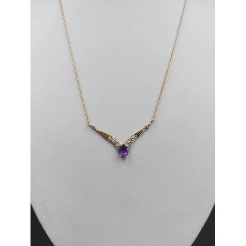 241 - A 9ct gold ladies necklace with two small inset diamonds and one central amethyst - approx. gross we... 