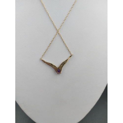 241 - A 9ct gold ladies necklace with two small inset diamonds and one central amethyst - approx. gross we... 