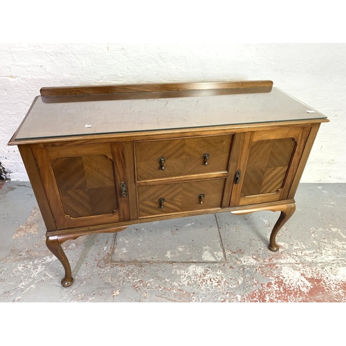 662 - A walnut and mahogany sideboard with two doors, two drawers and cabriole supports - approx. 98cm hig... 