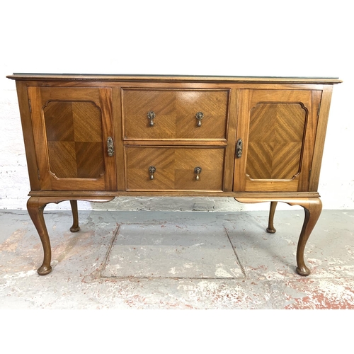 662 - A walnut and mahogany sideboard with two doors, two drawers and cabriole supports - approx. 98cm hig... 