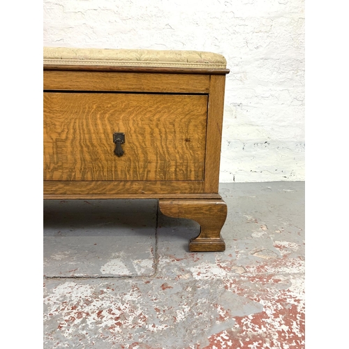 678 - An Edwardian oak wardrobe base storage bench with upholstered top - approx. 56cm high x 116cm wide x... 