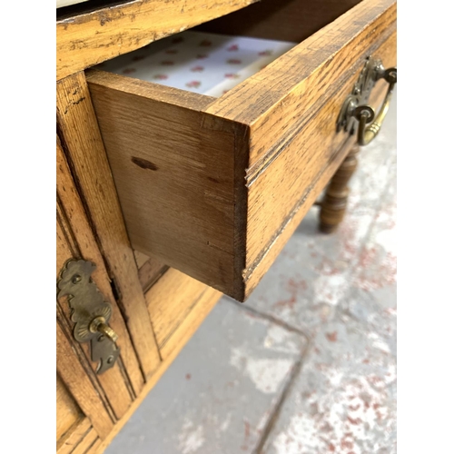 680 - A Griddle & Smith of Truro Aesthetic movement satinwood and oak washstand with white marble top and ... 